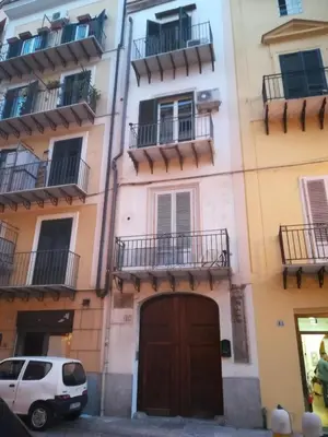 a white van parked in front of a building at bb45 superior holiday's house CIR 19082053C204471 in Palermo