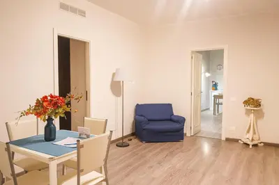 a living room with a table and a blue chair at bb45 superior holiday's house CIR 19082053C204471 in Palermo