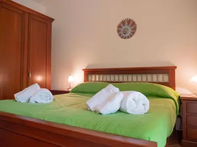 a bedroom with two rolls of towels on a bed at VILLA ANGELA TRABIA in Trabia