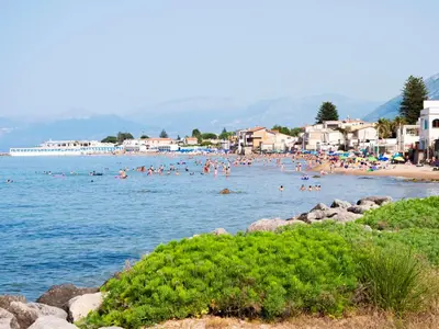 a group of people swimming in the water at a beach at VILLA ANGELA TRABIA in Trabia