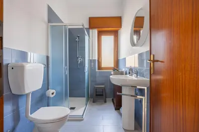 a bathroom with a toilet and a sink and a shower at Kastemar in Porticello