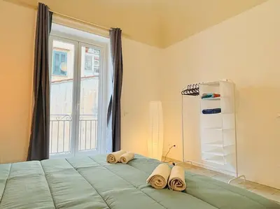 a bedroom with a large bed with towels on it at Corte del Tribunale in Palermo