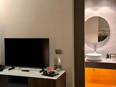 a flat screen tv sitting on a counter in a bathroom at Palazzo Liberty Unique Hotel by Geocharme in Palermo