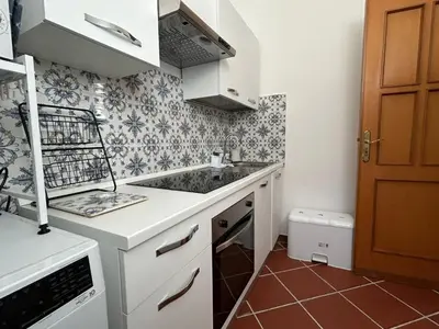 a small kitchen with a sink and a stove at Corte dei Re di Palermo Apartment in Palermo