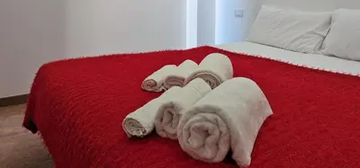 a red bed with towels on top of it at VISTA MARE in Alcamo Marina