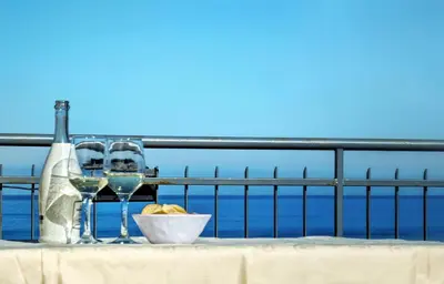 a table with two glasses of wine and a bowl of food at VISTA MARE in Alcamo Marina