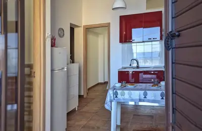 a kitchen with a table and a sink in it at VISTA MARE in Alcamo Marina