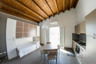 a kitchen with a desk and a table in a room at Villa Giambona in Isola delle Femmine