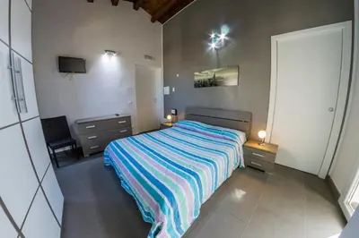 a bedroom with a bed and two night stands at Villa Giambona in Isola delle Femmine