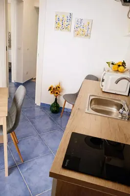 a kitchen with a sink and a counter top at Oikos Design Sicily in Castellammare del Golfo