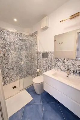 a bathroom with a tub and a toilet and a sink at Oikos Design Sicily in Castellammare del Golfo