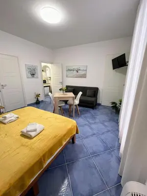 a living room with a table and a couch at Oikos Design Sicily in Castellammare del Golfo