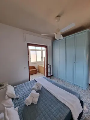 a bedroom with a large bed with towels on it at Villa Emilia Mondello Appartamento Emily con vista sul mare in Palermo