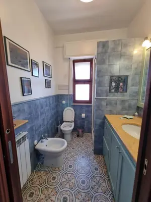 a bathroom with a toilet and a sink at Villa Emilia Mondello Appartamento Emily con vista sul mare in Palermo