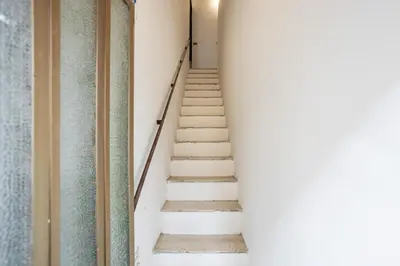 a staircase in a building with white walls and white steps at Case Billeci Casa Verde in Palermo