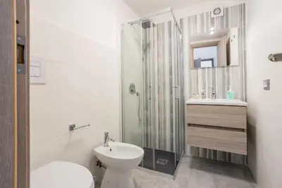 a bathroom with a shower and a toilet and a sink at Case Billeci Casa Verde in Palermo