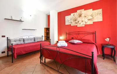 two beds in a room with red walls at 4 Bedroom Stunning Home In Trappeto in Trappeto