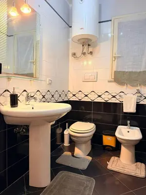 a bathroom with a sink and a toilet at Casa Julia in Palermo