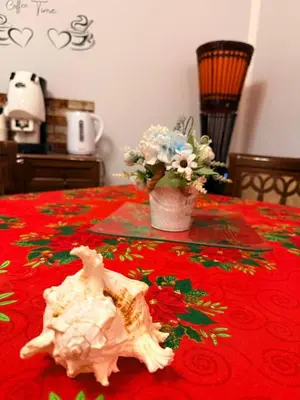 a table with a skull on a red table cloth with flowers at Casa Julia in Palermo