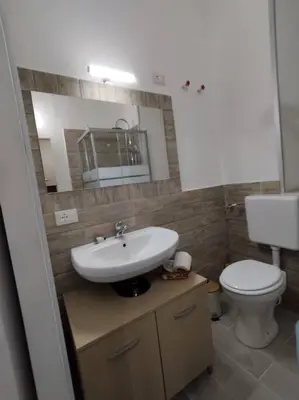 a bathroom with a sink and a toilet at Casa Veni Ka in Palermo