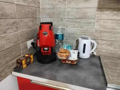 a red mixer sitting on a counter next to a coffee maker at Casa Veni Ka in Palermo