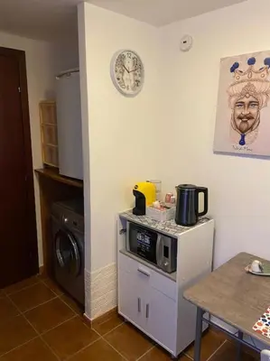 a kitchen with a microwave on top of a refrigerator at Petit Maison in Palermo