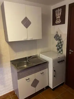a small kitchen with a sink and a counter at Petit Maison in Palermo