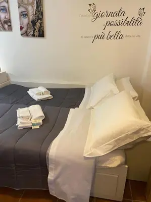 a bed with towels on top of it in a room at Petit Maison in Palermo