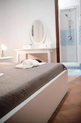 a bedroom with a bed with a sink and a mirror at Al bastione della pace in Palermo