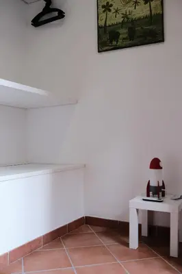 a white room with a table and a picture on the wall at Al bastione della pace in Palermo