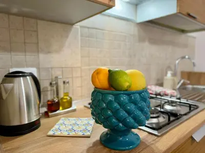 a bowl of fruit sitting on top of a kitchen counter at La Dimora di Anna e Ciccio in Casteldaccia