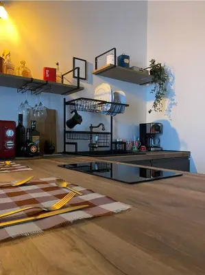 a kitchen with shelves and a wooden floor at La Barbera's apatments old town PA in Palermo
