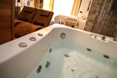 a large bath tub in a bathroom with a couch at Casita Garden&Spa in Carini