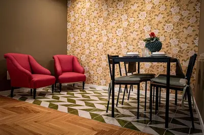 a dining room with a table and two chairs and a table and chairs at Casa Verderame in Palermo