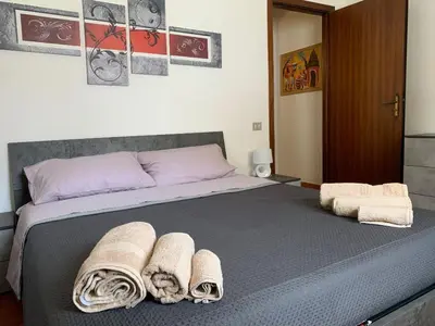 a bedroom with a large bed with towels on it at GEORGE PENTHOUSE Attico PALERMO in Palermo