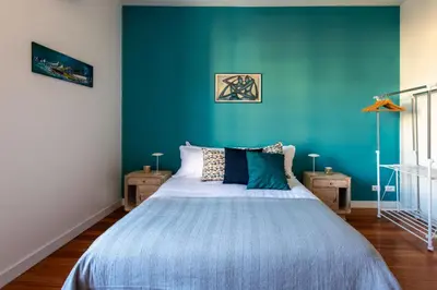 a bedroom with a blue wall and a bed at Casa Madà vicino al Politeama by Wonderful Italy in Palermo