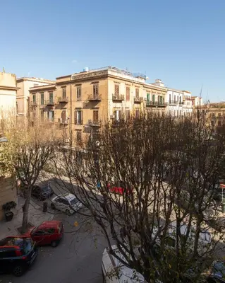 a view of a building with cars parked in a parking lot at Casa Madà vicino al Politeama by Wonderful Italy in Palermo