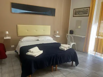 a bedroom with a bed with towels on it at Maqueda Vibes in Palermo