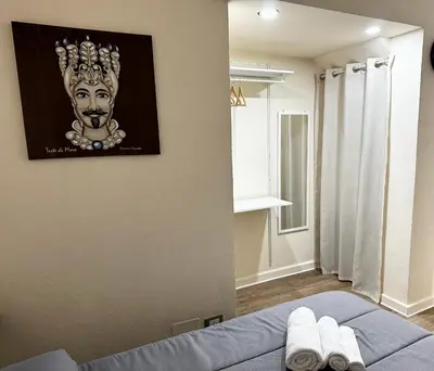 a room with a bed with a picture on the wall at Merlino Smarthouse alla Zisa in Palermo