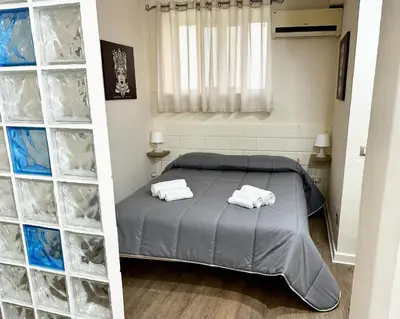 a bedroom with a bed and some plastic containers at Merlino Smarthouse alla Zisa in Palermo