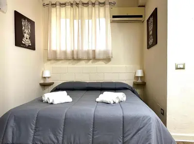 two towels on a blue bed in a room at Merlino Smarthouse alla Zisa in Palermo