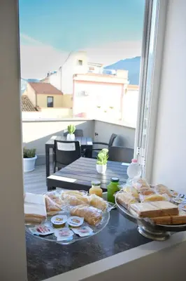 a table with bread and pastries on a balcony at Da 'Nfacci Affittacamere in Carini