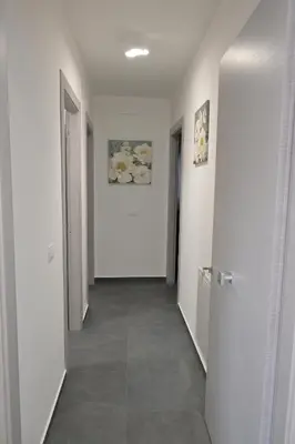 a hallway with white walls and a tile floor at Da 'Nfacci Affittacamere in Carini