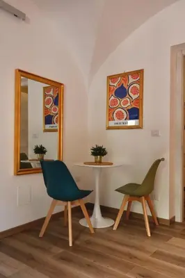 a room with two chairs and a table and a mirror at Due Sicilie Ballarò in Palermo