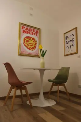 a table with two chairs and a vase with a flower at Due Sicilie Ballarò in Palermo
