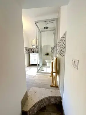 a bathroom with a walk in shower and a mirror at Due Sicilie Ballarò in Palermo