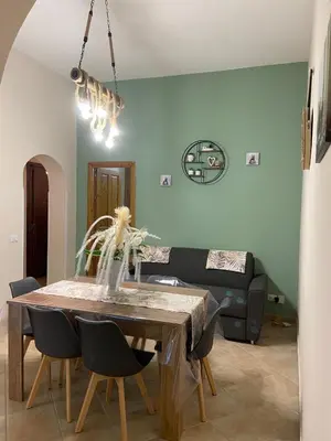 a dining room with a table and a couch at CASA MAGIEM in Palermo