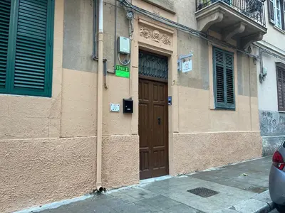 a building with a brown door on the side of it at CASA MAGIEM in Palermo
