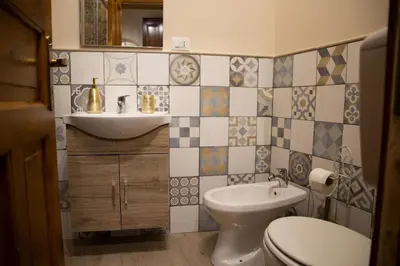 a bathroom with a white toilet and a sink at CASA MAGIEM in Palermo
