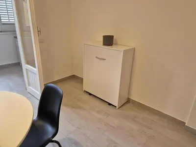 a living room with a television and a red ottoman at MaGi Mondello in Mondello